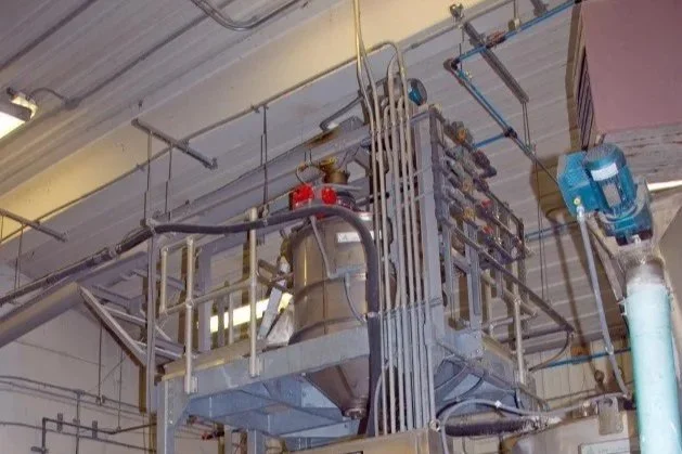 Industrial equipment and piping in a factory setting.