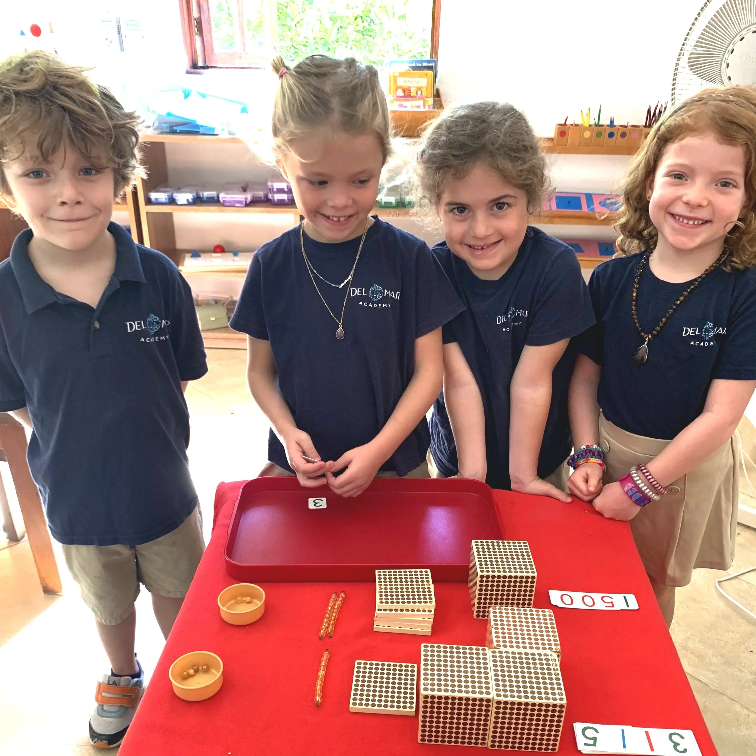 Four kindergarten students using Montessori sensory materials in bilingual school in Costa Rica