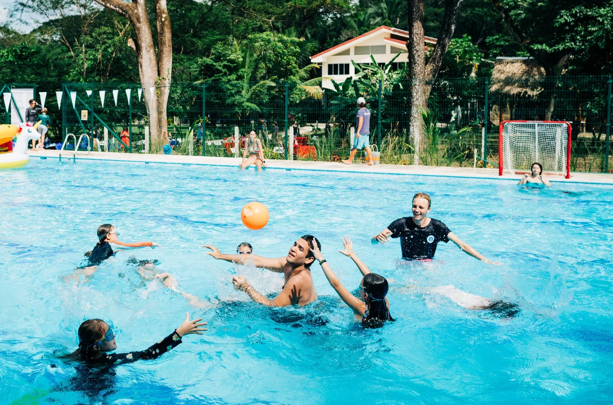 High school students playing water polo in on-campus pool at Del Mar Academy in Nosara