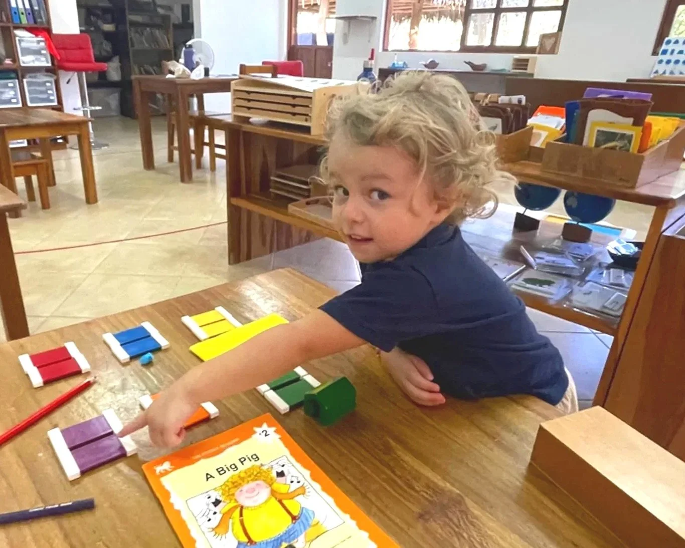 Kindergarten student using colorful sensory materials in bilingual Montessori school in Costa Rica
