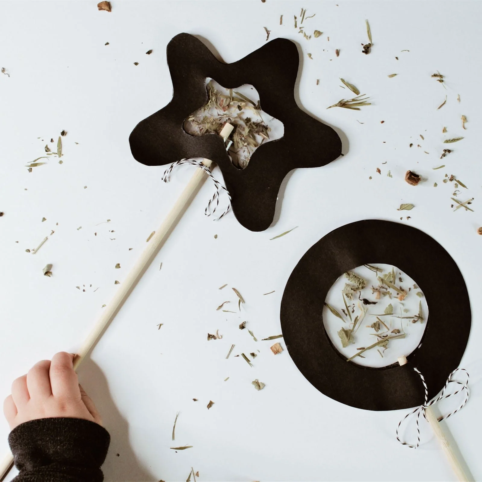 Toddler holding completed nature wand