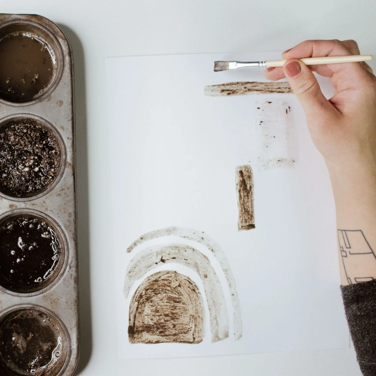 Creating a mud painting for nature school