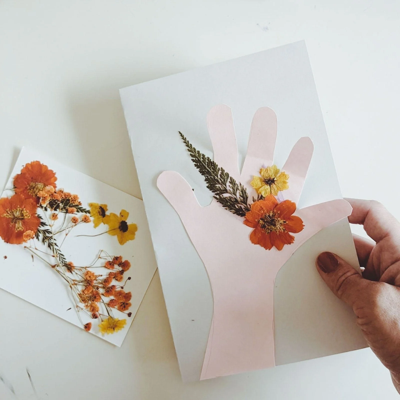 Completed handprint bouquet card using dried flowers