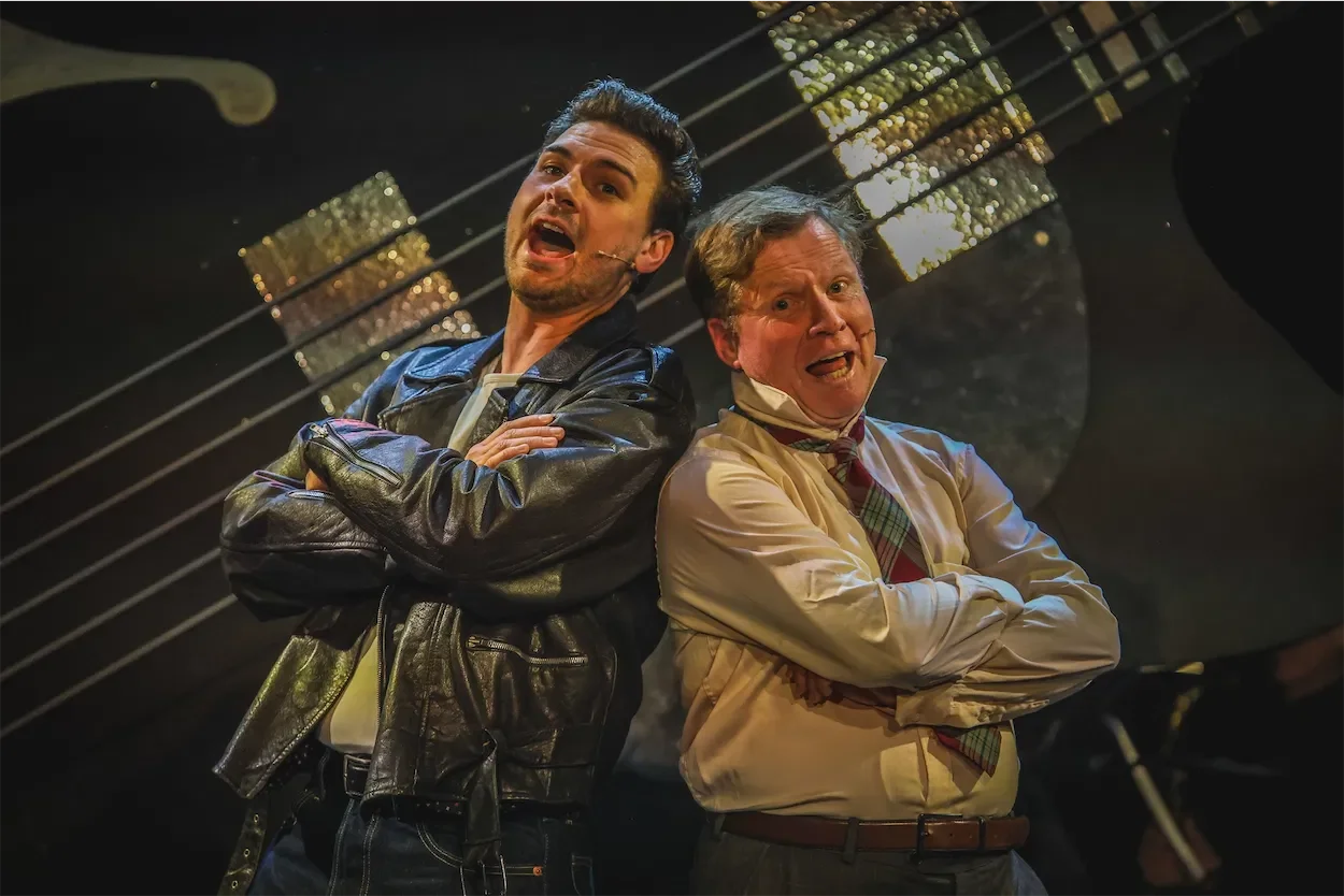 Ian Prosser on stage with fellow actor singing in a production of All Shook Up