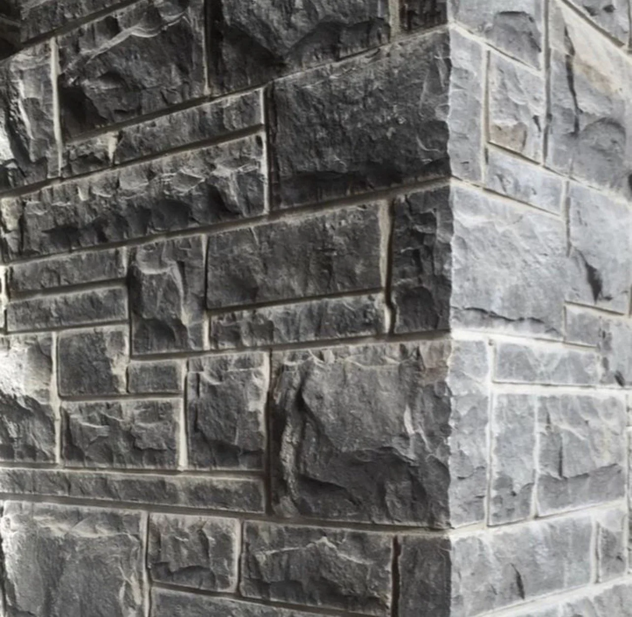Architectural-grade split-face limestone wall using Ottawa Platinum stone blocks for exterior cladding in residential or commercial masonry applications