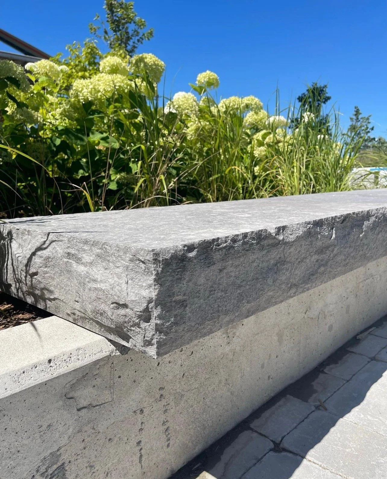 Architectural bench featuring rock-face Ottawa Platinum limestone block, used in modern landscape design and hardscaping applications