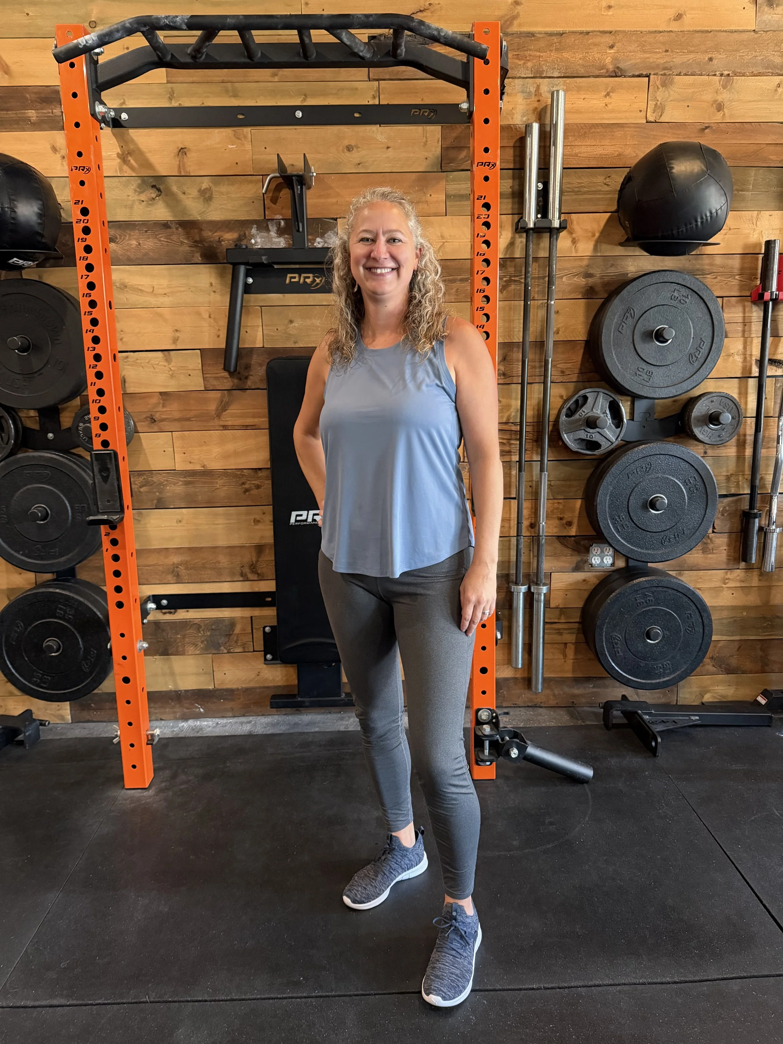 Owner in front of workout equipment