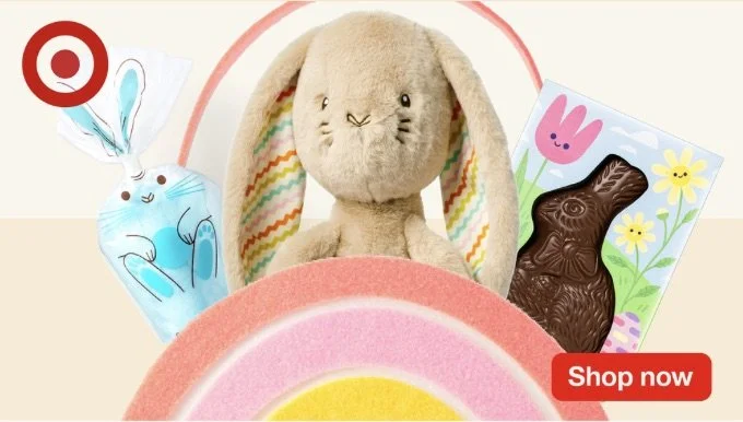 Easter-themed display with a plush bunny, chocolate rabbit, and colorful decorations.