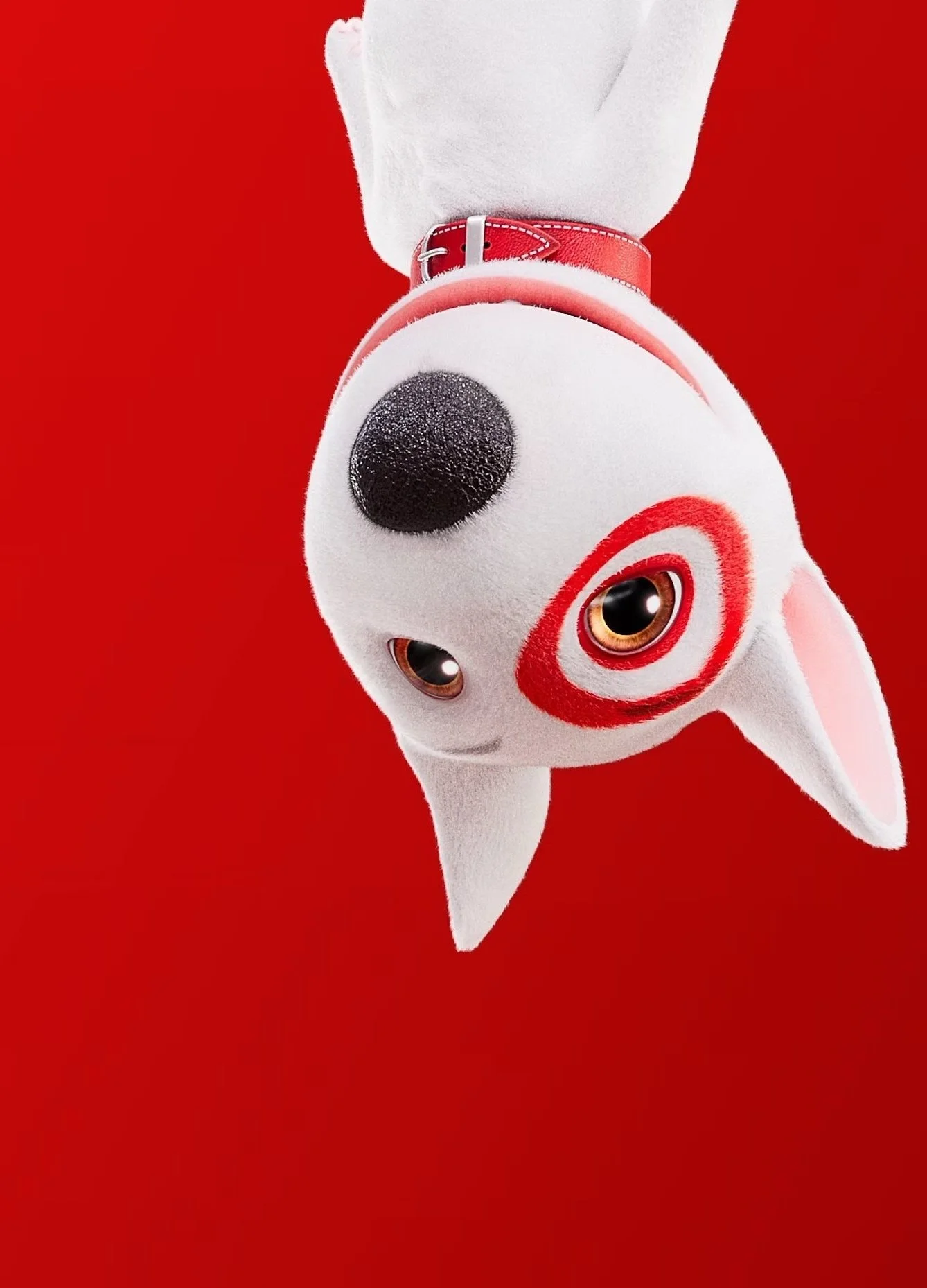 A white plush toy dog with black nose, big eyes, red target on its cheek, wearing a pink collar, lying against a red background.