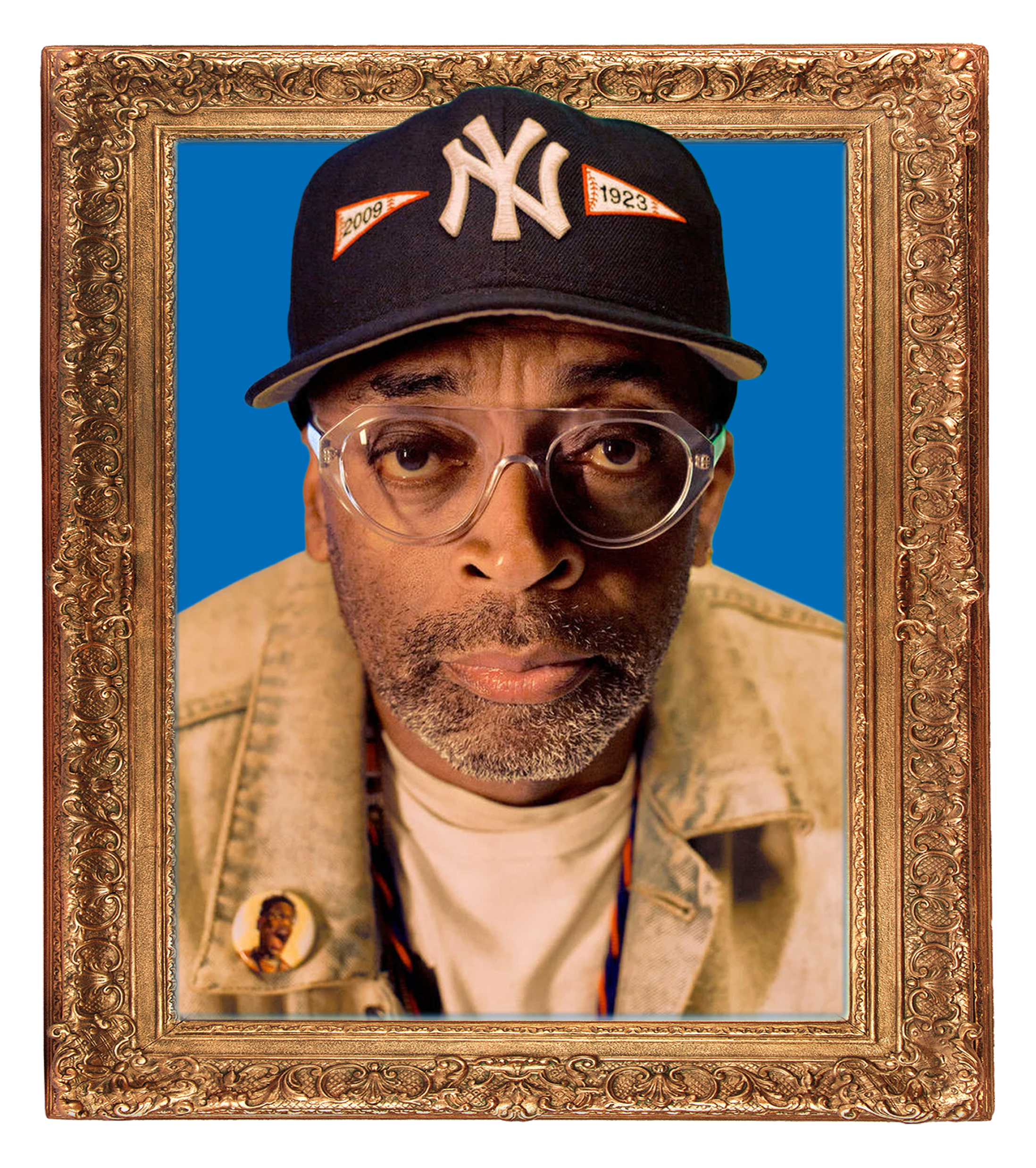 Close-up of a vintage portrait featuring a man wearing glasses and a dark baseball cap with the New York Yankees logo, an orange patch with 2009 and 1923, and a pinned badge of a woman, inside an ornate gold frame with a blue background.