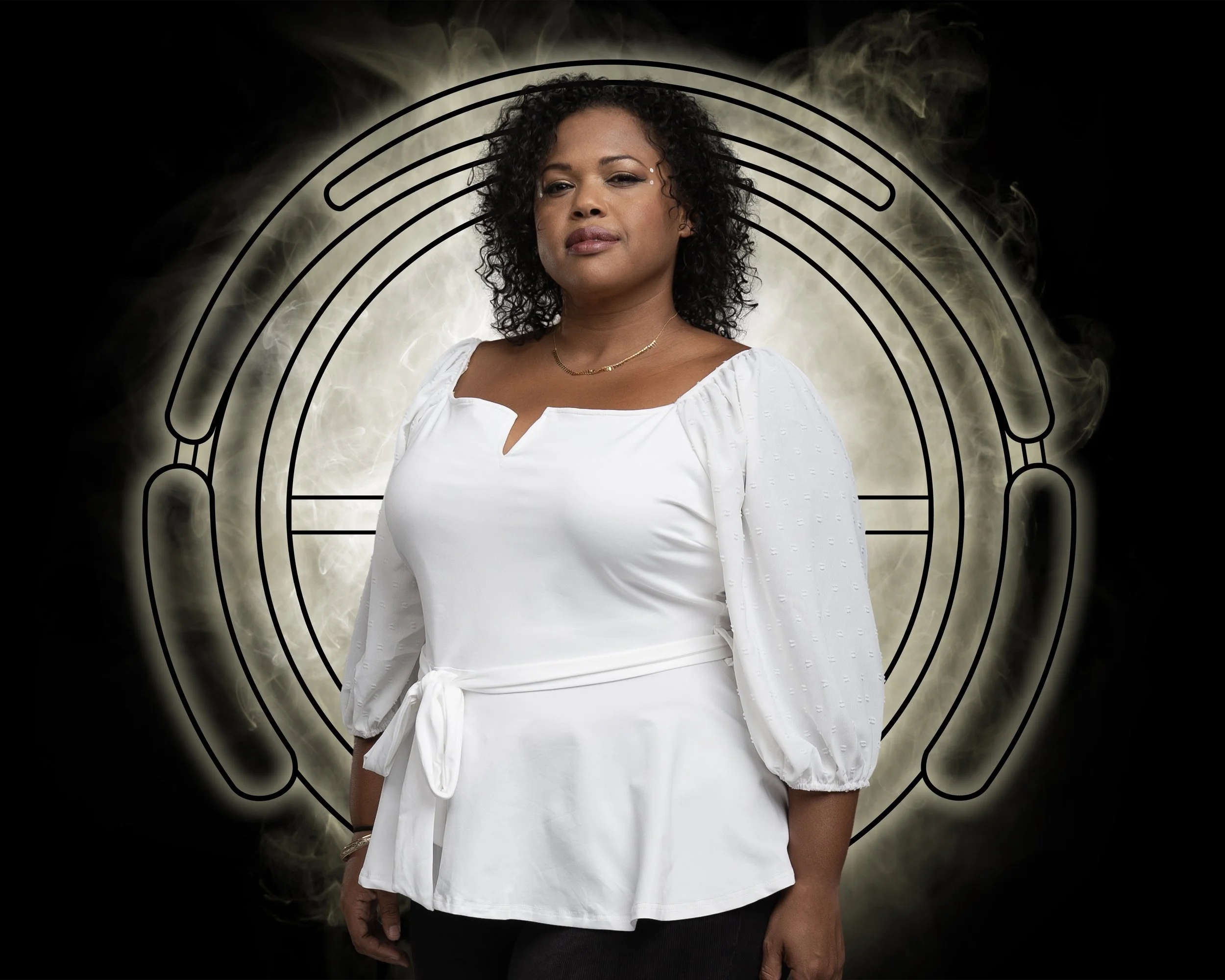 Portrait of Ella, a woman standing, looking confidently at the camera.