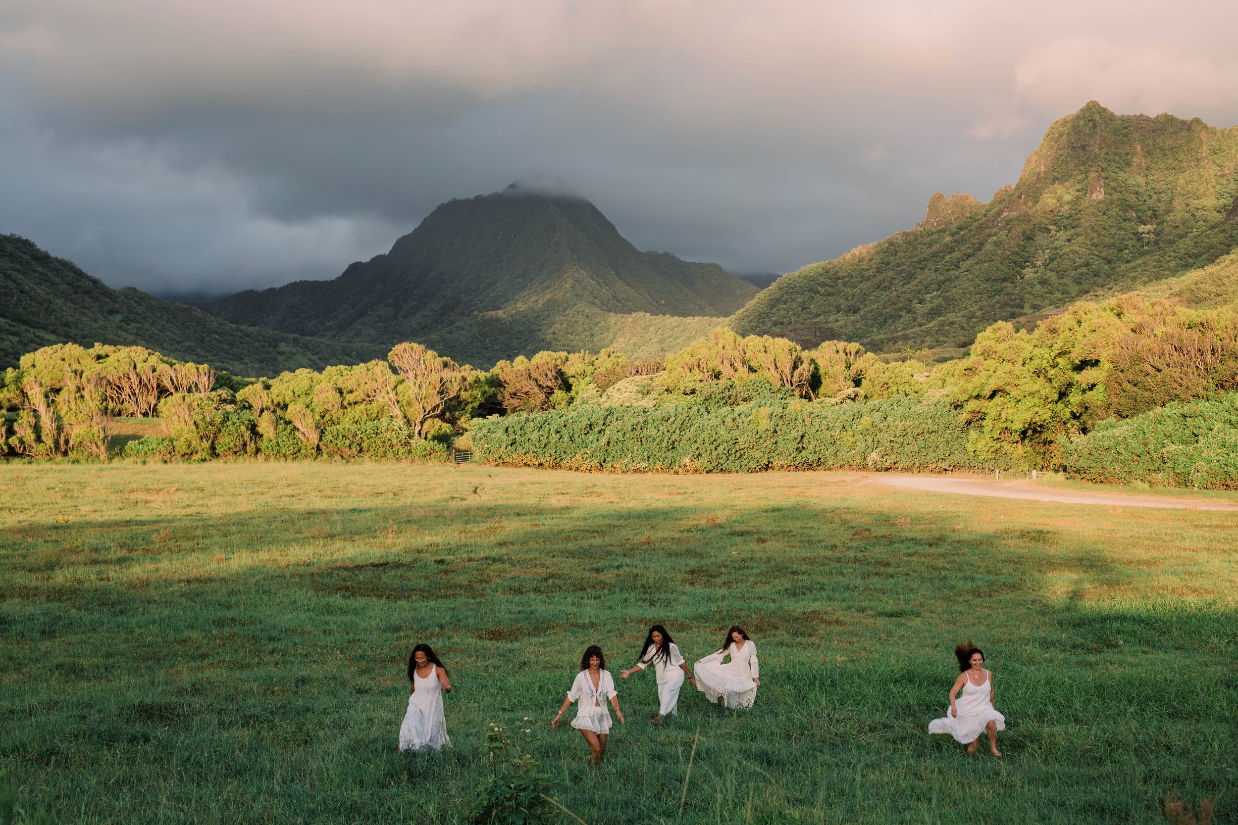 woman walking barefoot through grass in Hawaiʻi