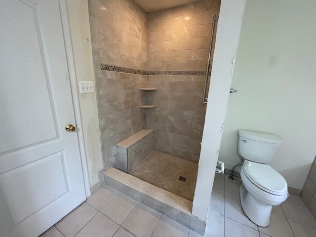 Bathroom with a walk-in shower and a toilet.