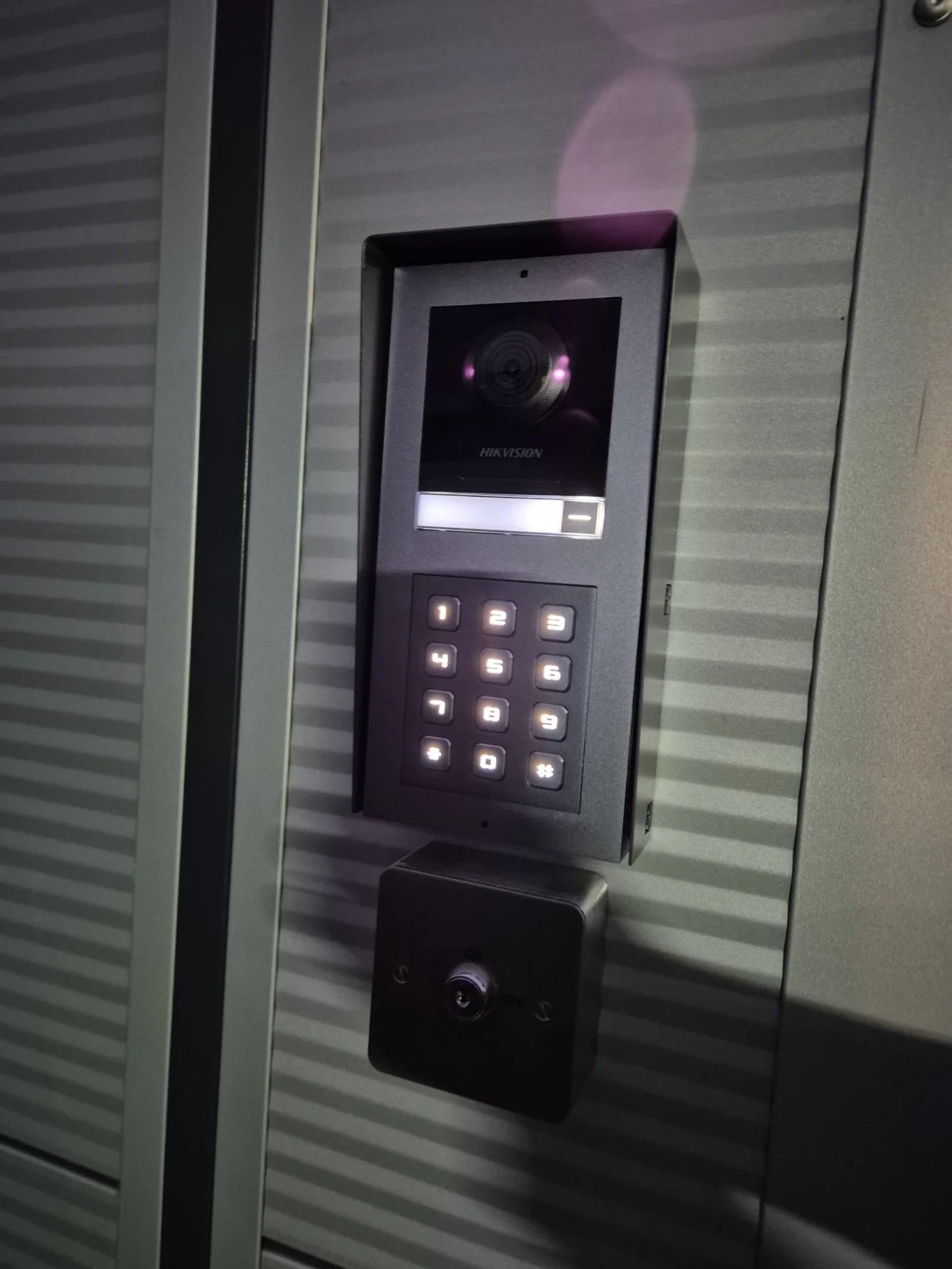 Security access panel with a camera, number keypad, and a scanner mounted on a wall.