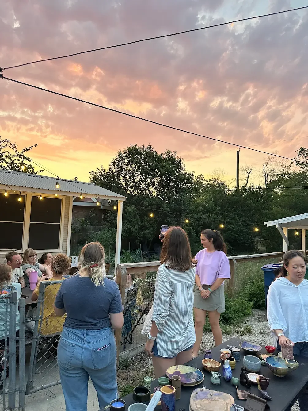 Young adults enjoying an outdoor gathering at sunset, representing connection and community—key themes in anxiety therapy and trauma therapy for clients in their 20s and 30s in Largo, Florida and San Antonio, Texas.