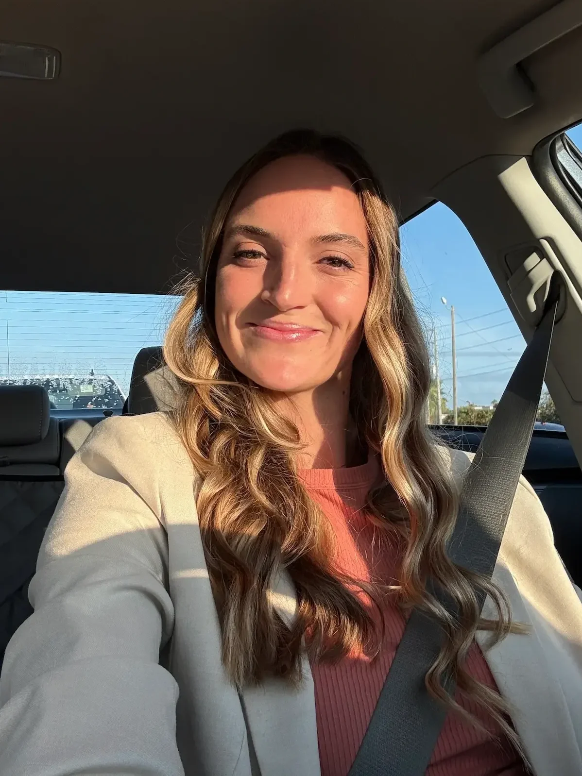Largo, Florida and San Antonio, Texas therapist specializing in EMDR therapy, anxiety therapy, and trauma therapy, smiling in natural sunlight during a car ride.