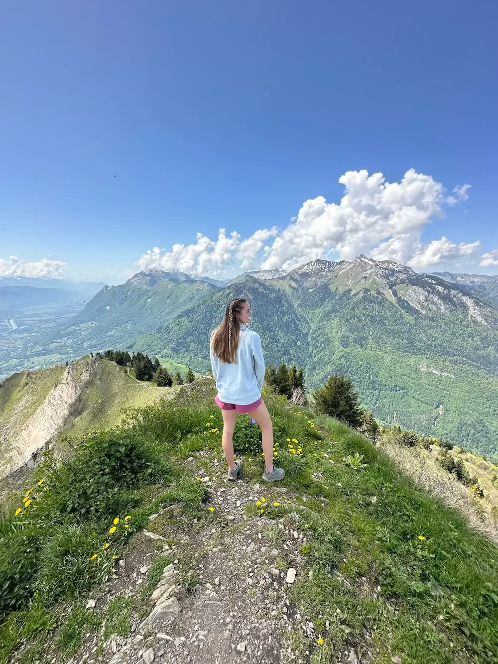 Addy Allen, EMDR therapist in Largo, Florida and San Antonio, Texas, standing on a mountain trail overlooking lush valleys—symbolizing healing, resilience, and the journey through trauma therapy and anxiety therapy.