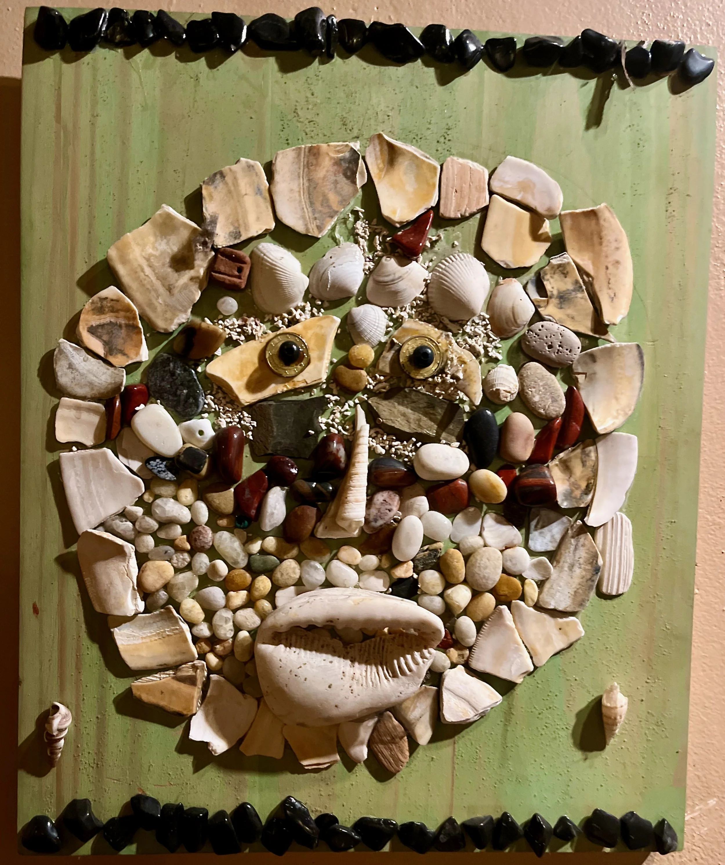 "Oceanus" 2021, shells, coins, stone and acrylic on wood, 15" x 12.5"