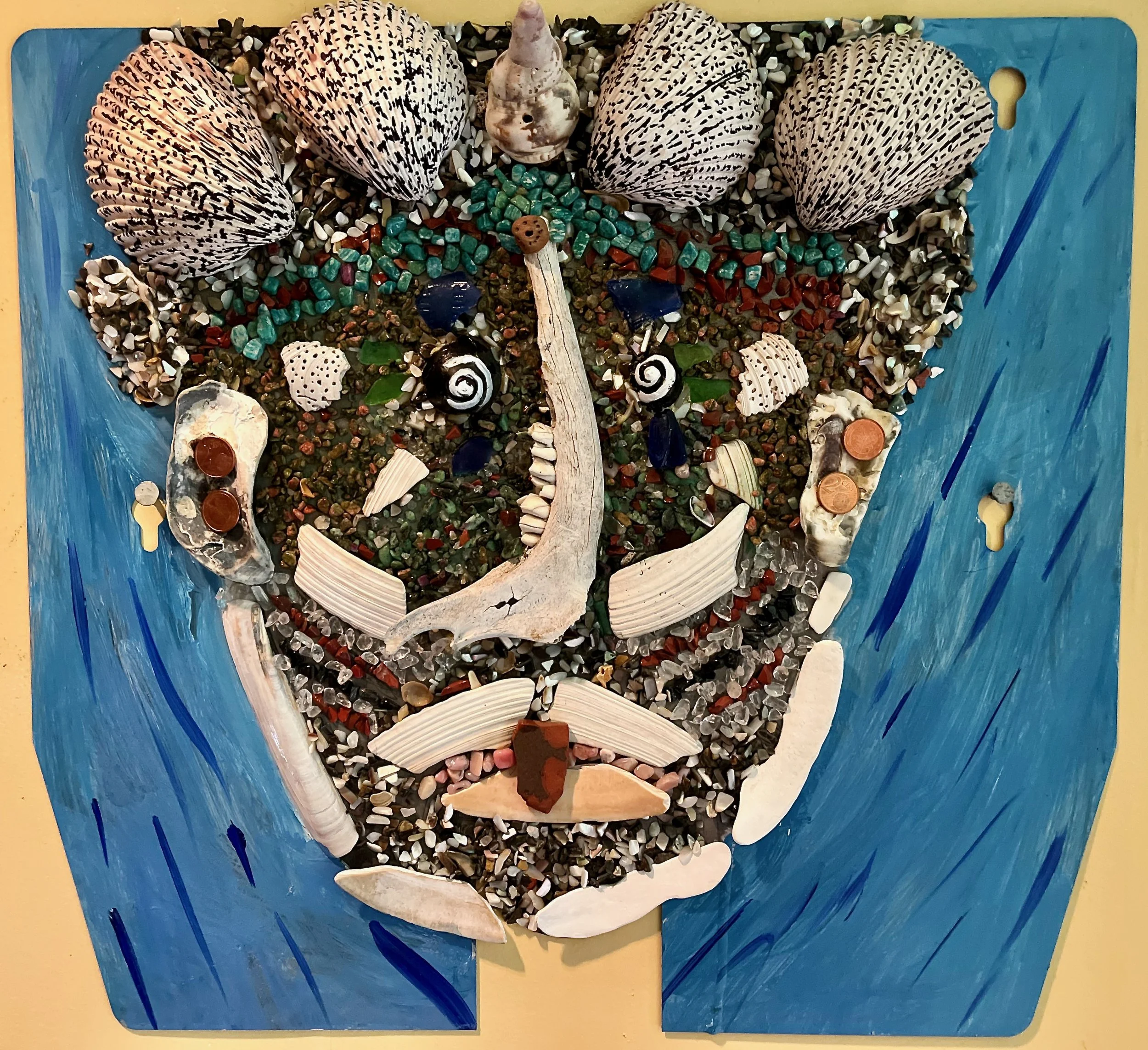 "Merman" 2021, shells, bones, glass and acrylic on metal, 18" x 19.5"