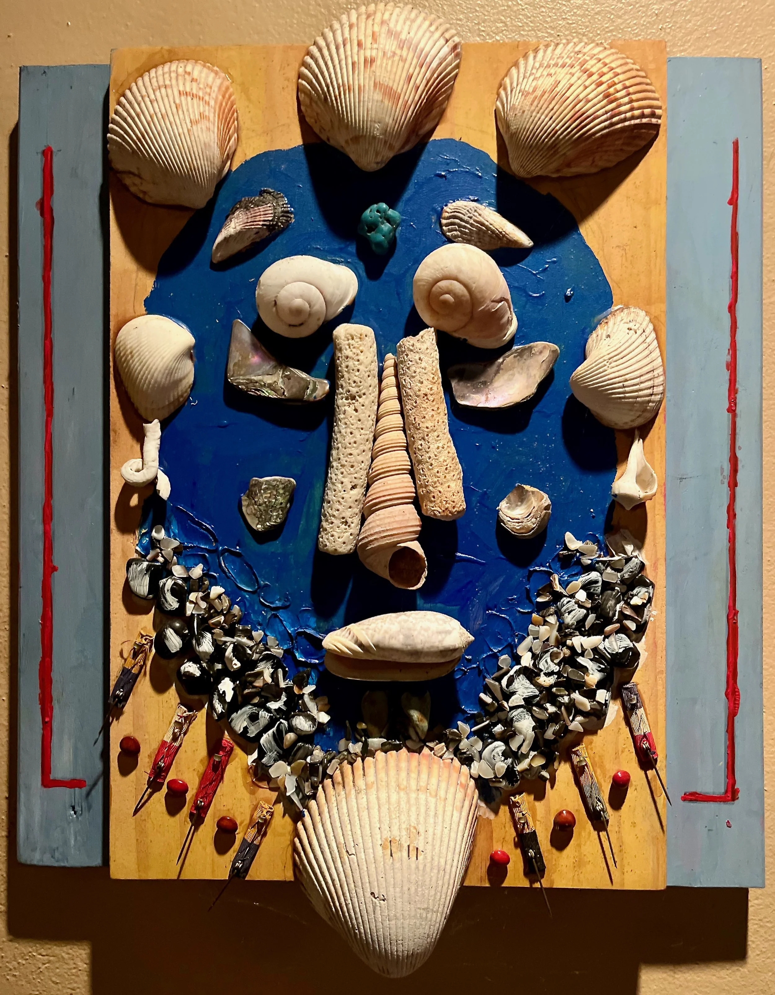 "Poseidon" 2021, Boy Scout badges, shells, stone and acrylic on wood, 14" x 13"