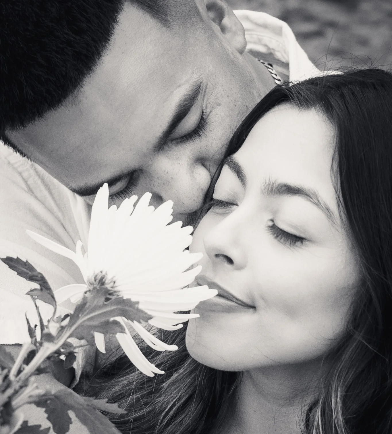 Couples pose with a flower during couples' shoot.