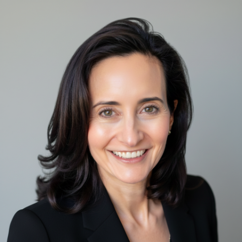 Professional woman with shoulder-length dark brown hair smiling against a plain gray background.