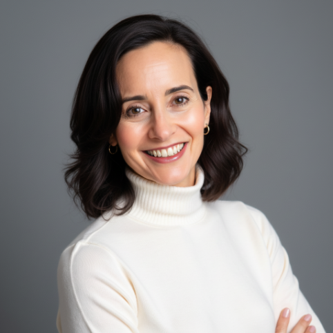 Portrait of a smiling woman with shoulder-length dark hair, wearing a white turtleneck sweater, against a gray background.