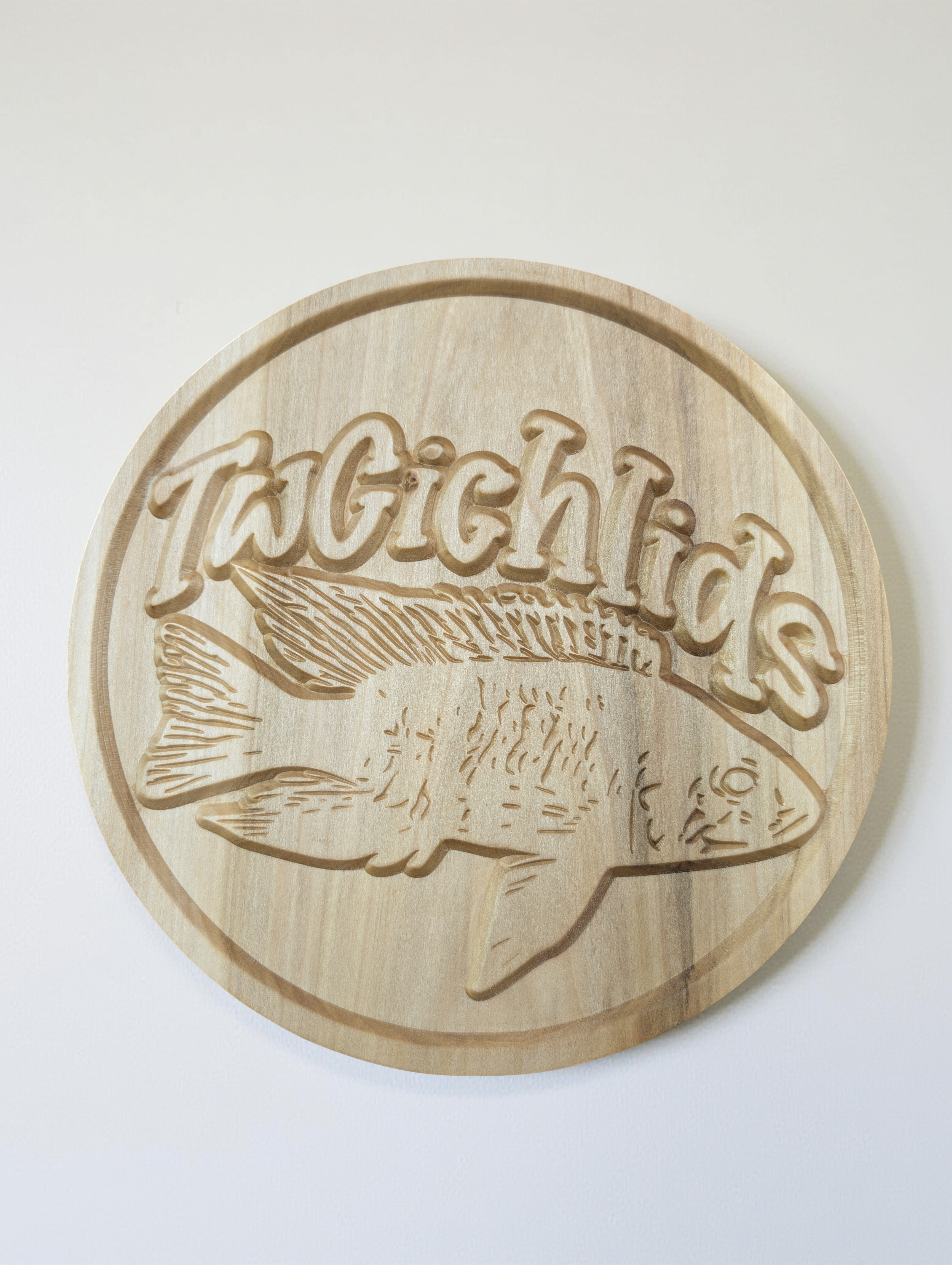 This distinctive round sign was custom-carved for TwCichlids, showcasing their unique brand identity with a precision-machined fish emblem and stylized text.

Crafted from solid Poplar, this piece demonstrates our capability to transform a digital lo