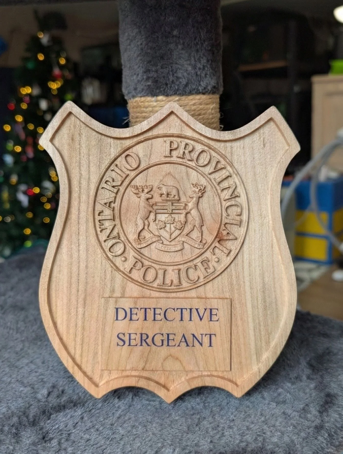 A precision carved solid wood shield featuring the Ontario Provincial Police crest in 3D relief. Fully customizable with rank, name, or badge number.