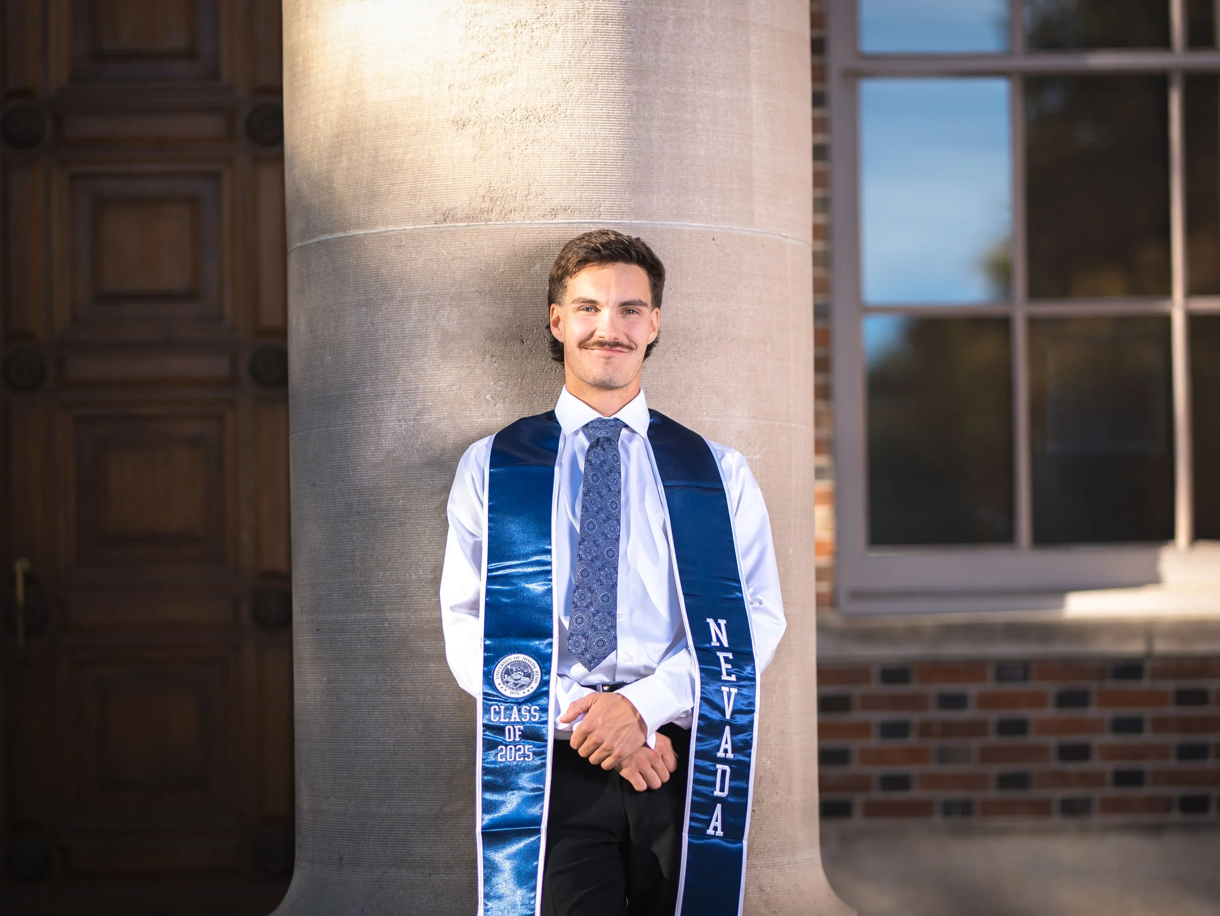 A young man in a professional graduation photo taken in Reno, Nevada.