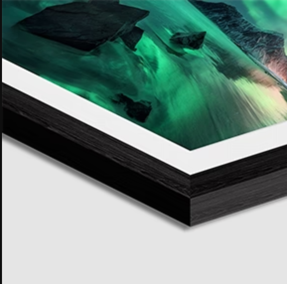 Close-up of a modern electronic tablet with a vivid green and black abstract image on the screen.