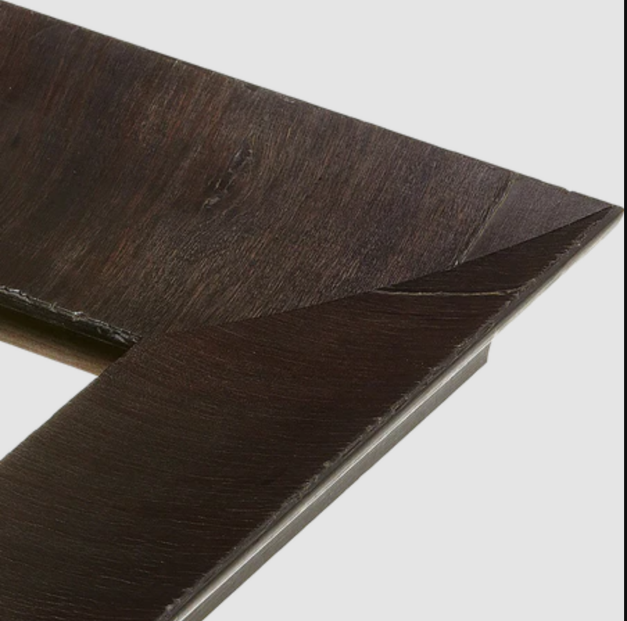 A close-up of a dark brown wooden picture frame with a beveled edge.