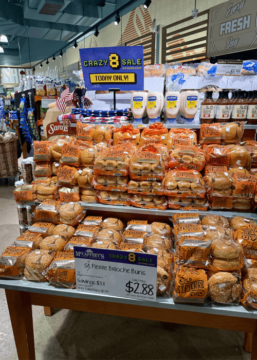 View of St. Pierr'es brioche rolls withMcCaffrey's Crazy 8 sale sign and 11x17 sign