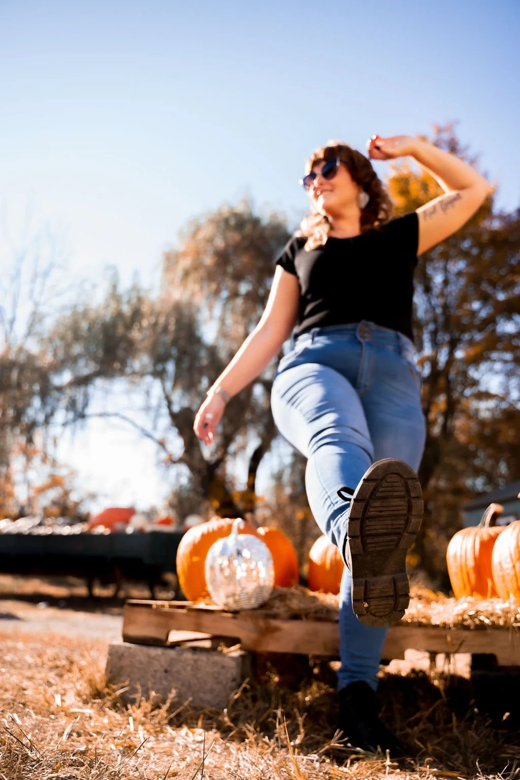 Felicia candid photo with disco ball pumpkin and real pumpkins behind