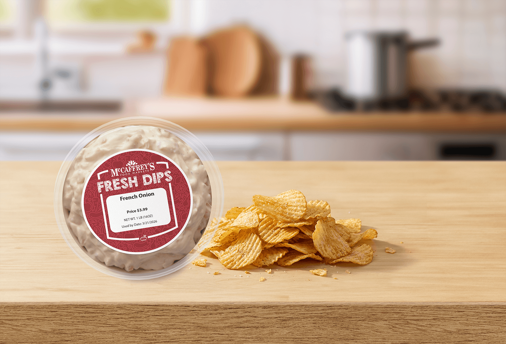 Front view of McCaffrey's french onion dip lid with pile of potato chips on wooden kitchen counter