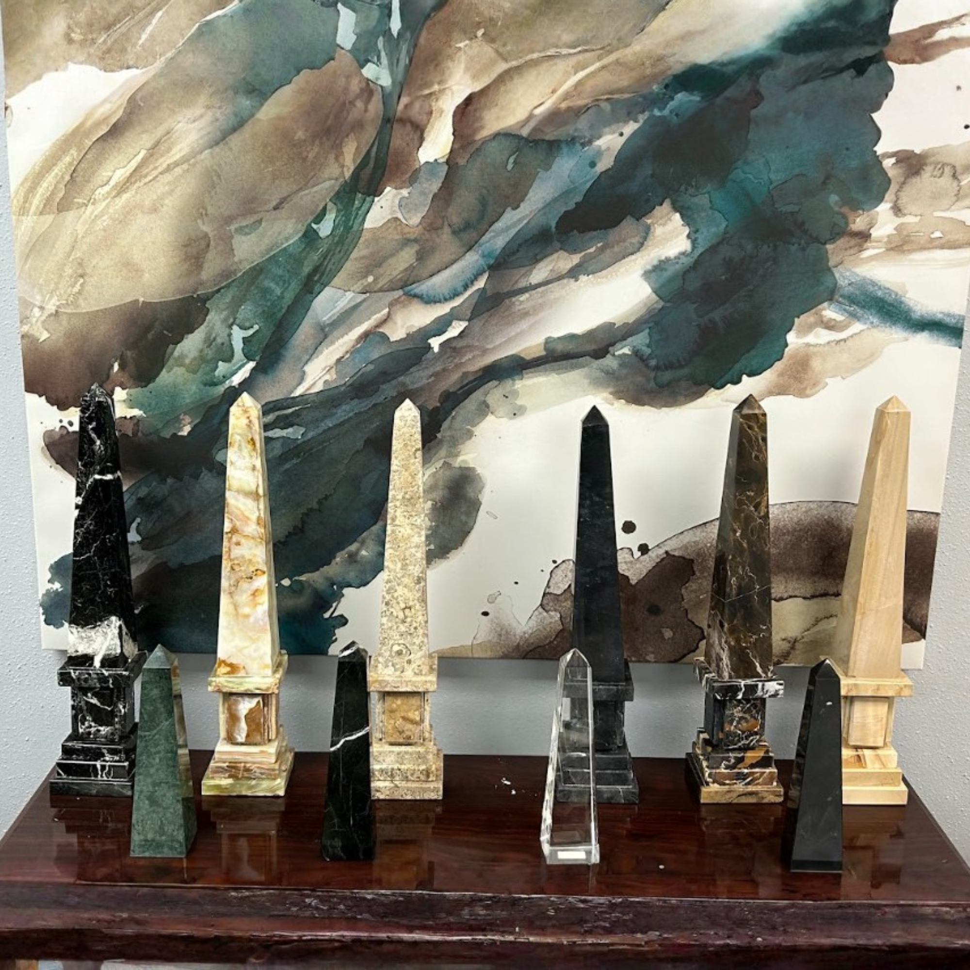 Various marble and stone slabs on display on wooden shelves.
