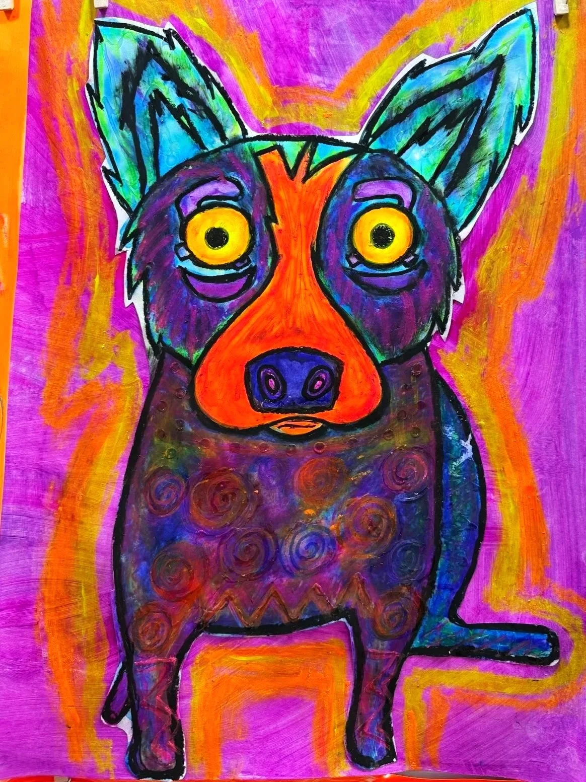 Colorful painting of a dog with large yellow eyes, purple and blue fur with swirl patterns, orange nose, and green ears, set against a vibrant pink, orange, and yellow abstract background.