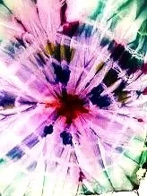 Abstract colorful tie-dye pattern with radiating lines in purple, pink, green, and black.
