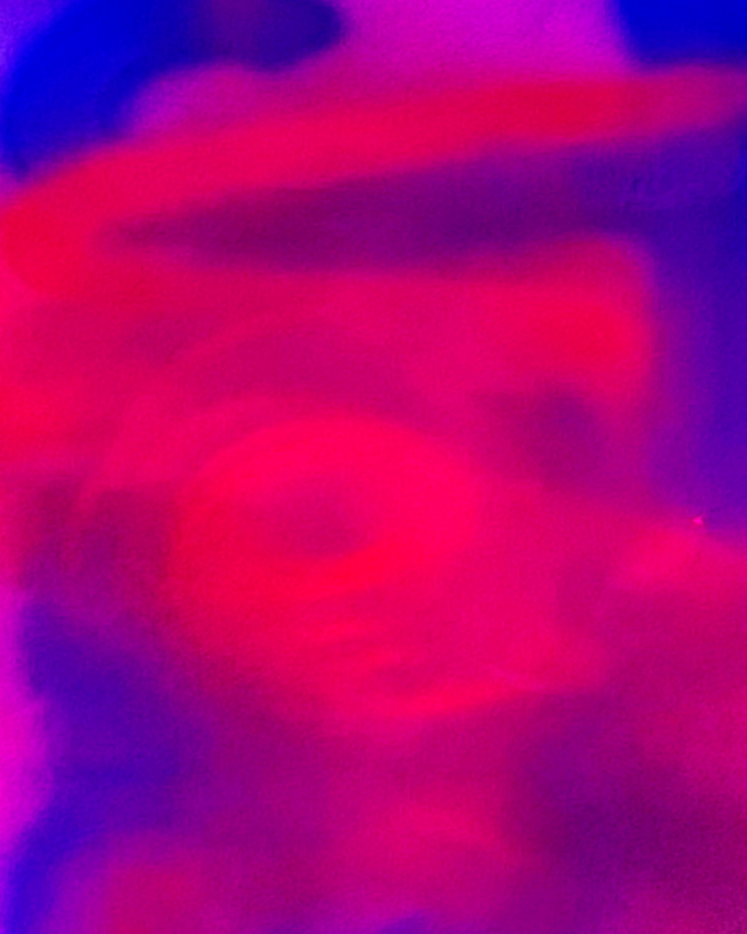 Close-up of pink lips with vibrant purple and blue lighting