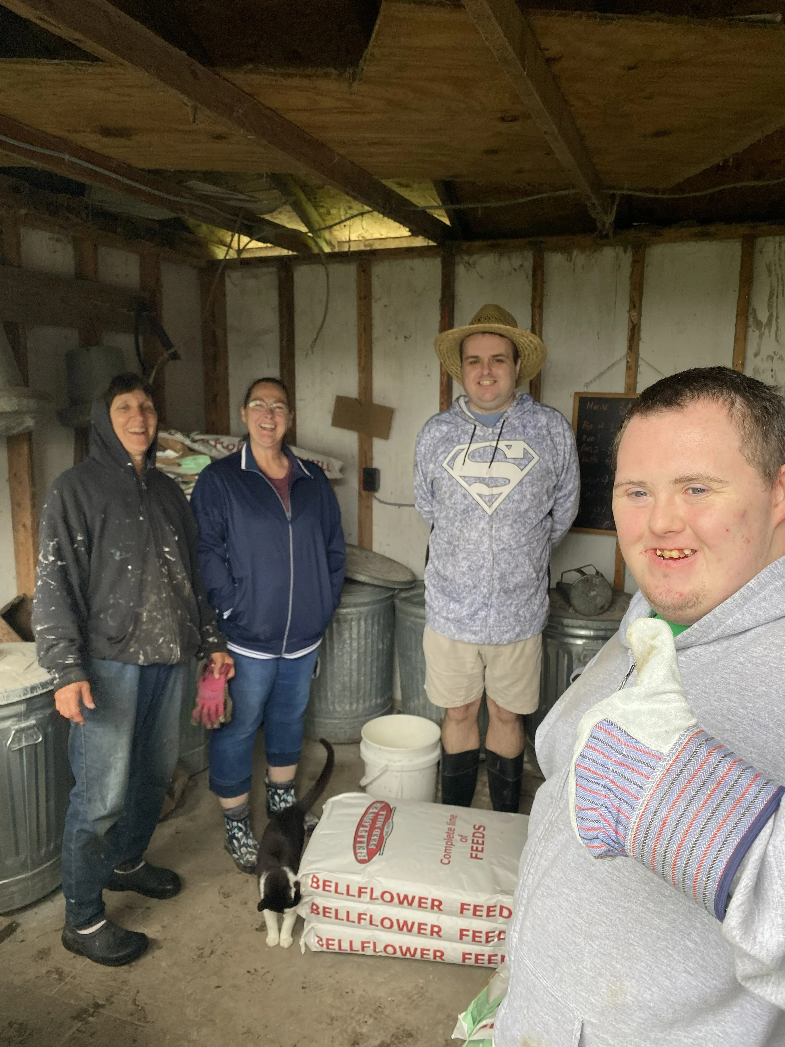 Participants from Kindness Opportunities helping with daily animal care at Joy of Illinois Farm.