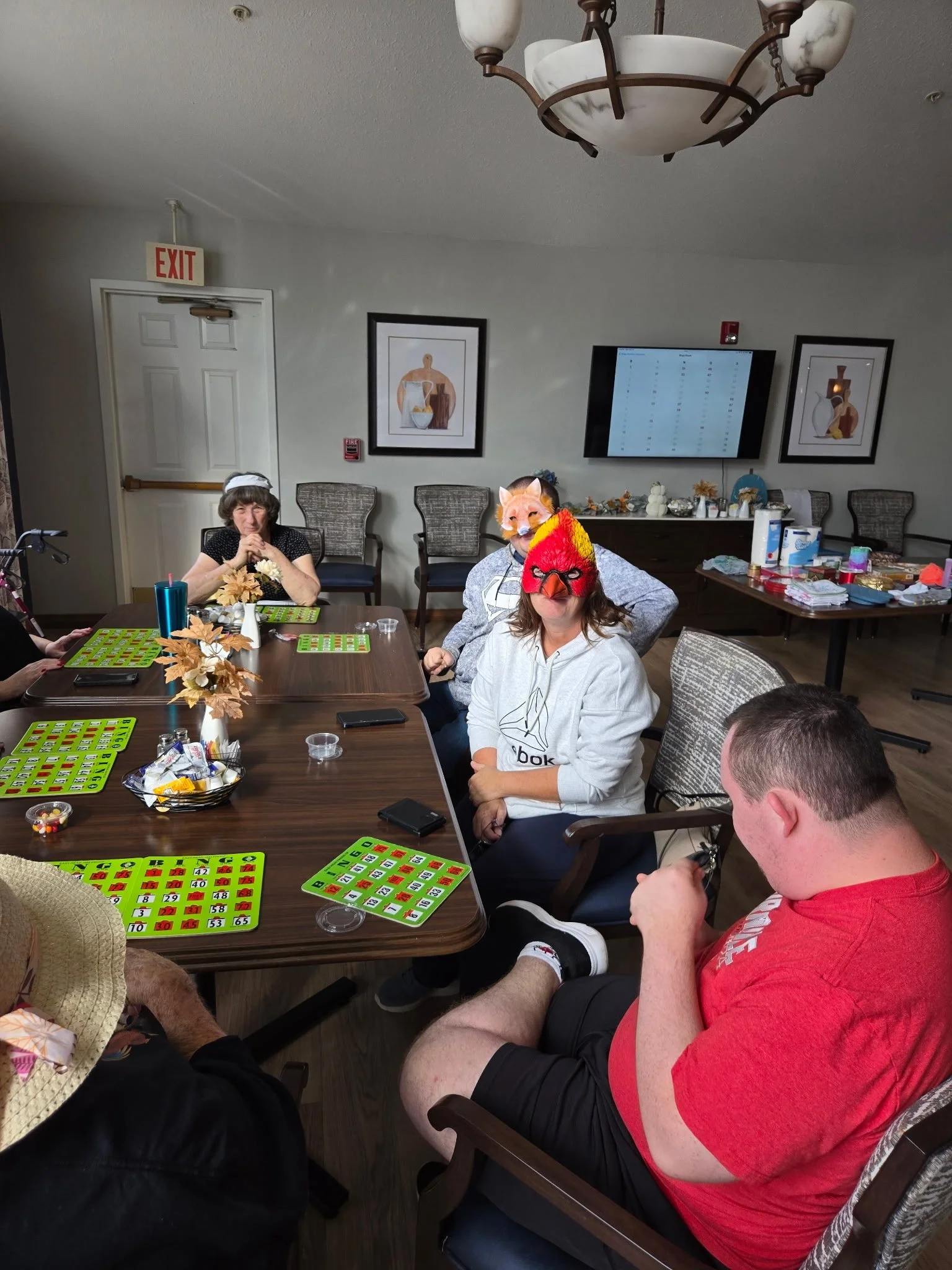 Jack, Chance, and Amanda volunteering at a senior center by helping with Halloween crafts and playing bingo.
