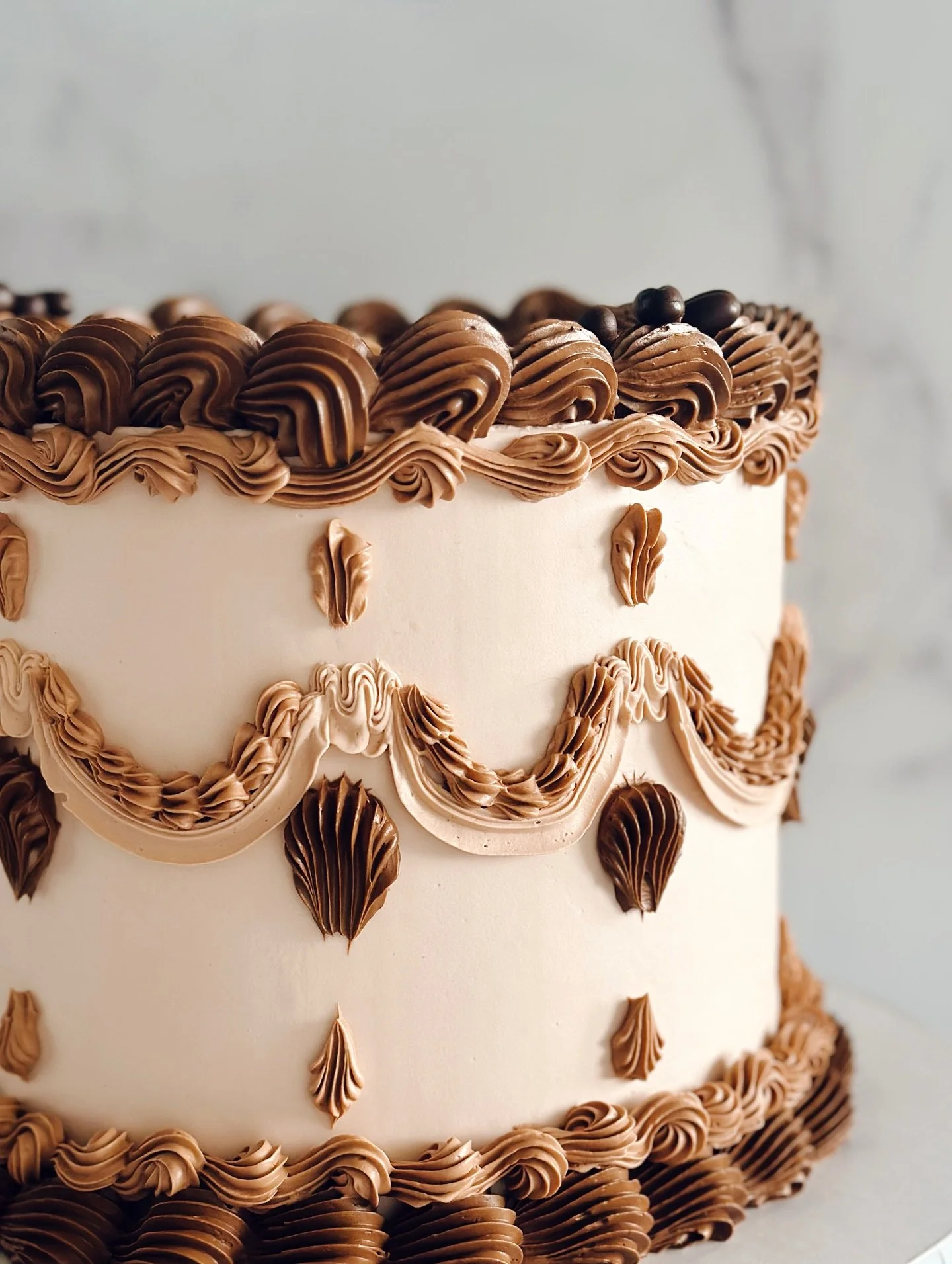 Espresso tones, vintage piping, and a custom cannoli cake flavor made this one a showstopper ☕️🍰⁠ (sorry but this post is *begging* for a Sabrina Carpenter musical cue 😅)
⁠
This espresso-themed beauty was created for a joint celebration&mdash;and i