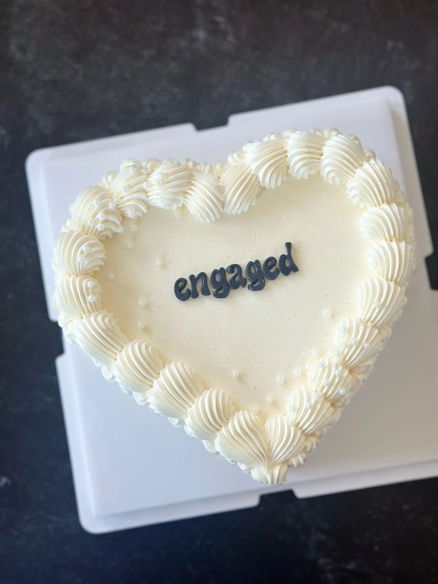 A cute little vintage heart cake for an engagement celebration 🤍✨
I had so much fun decorating this engagement cake &mdash; clean piping, delicate pearl details, and a simple statement in the center. Sometimes less really is more. #njcakes #jerseyci