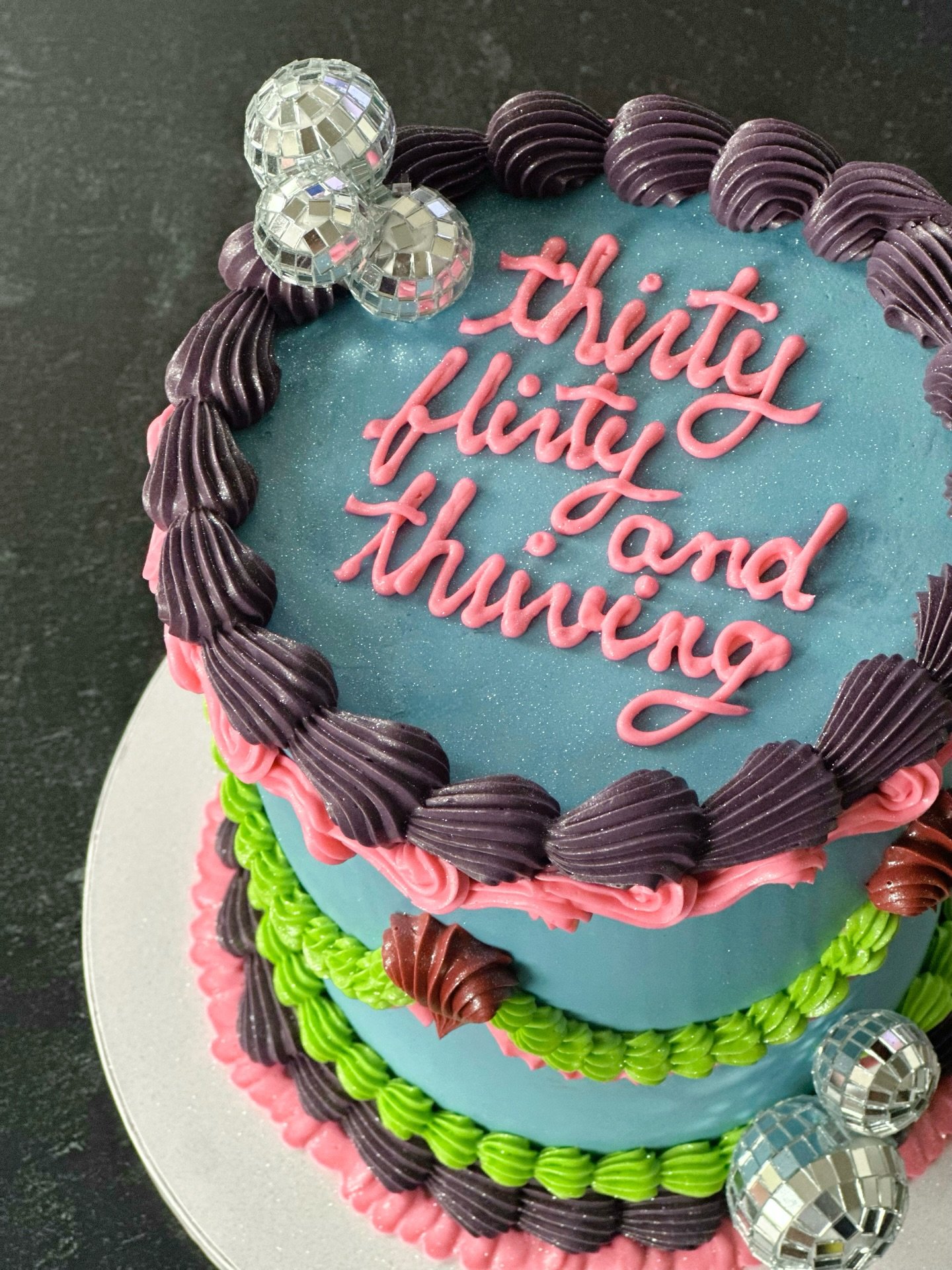 A *second* 13 Going On 30 cake? YES ✅ 🎉 

I adore a cake that uses vibrant colors like the ones used here&mdash;in this case, based on the main character&rsquo;s iconic dress. 

This cake was for a returning client who always trusts me to produce so