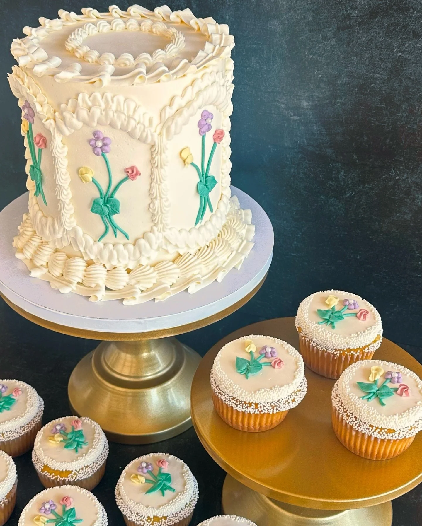 This is one of my very favorite kind of cakes to do&mdash;floral, vintage, very delicate and just perfect for a springtime celebration. 🌺 

The cupcakes decorated to match? Perfect. They complement the design so well and add so much to a dessert dis