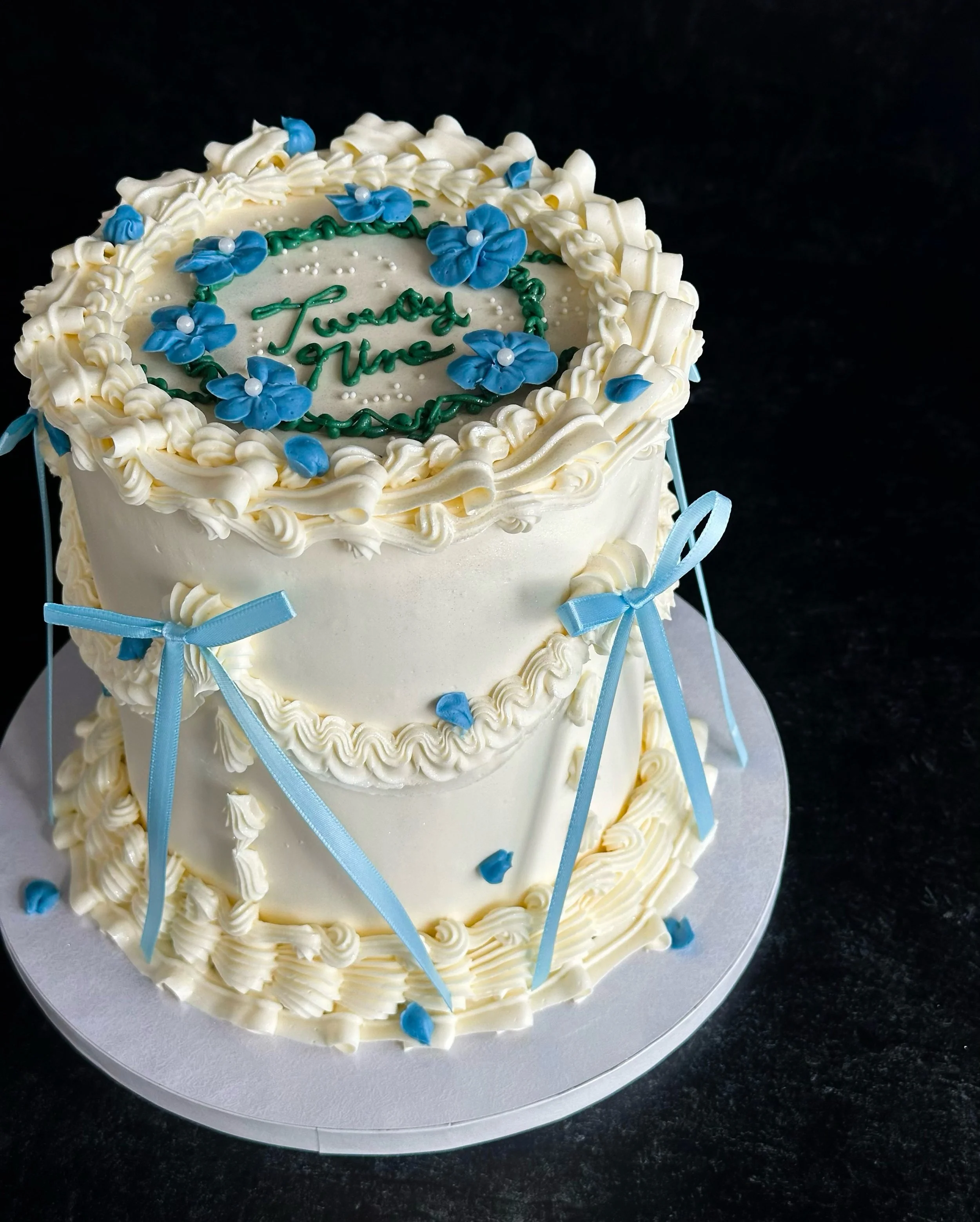 Cakes like this are my very favorite kind of cake to decorate&mdash;vintage piping style in a creamy ivory hue, with ruffles and swags, and a crown of delicate buttercream flowers with sugar pearl centers to complete the cake. I can&rsquo;t think of 