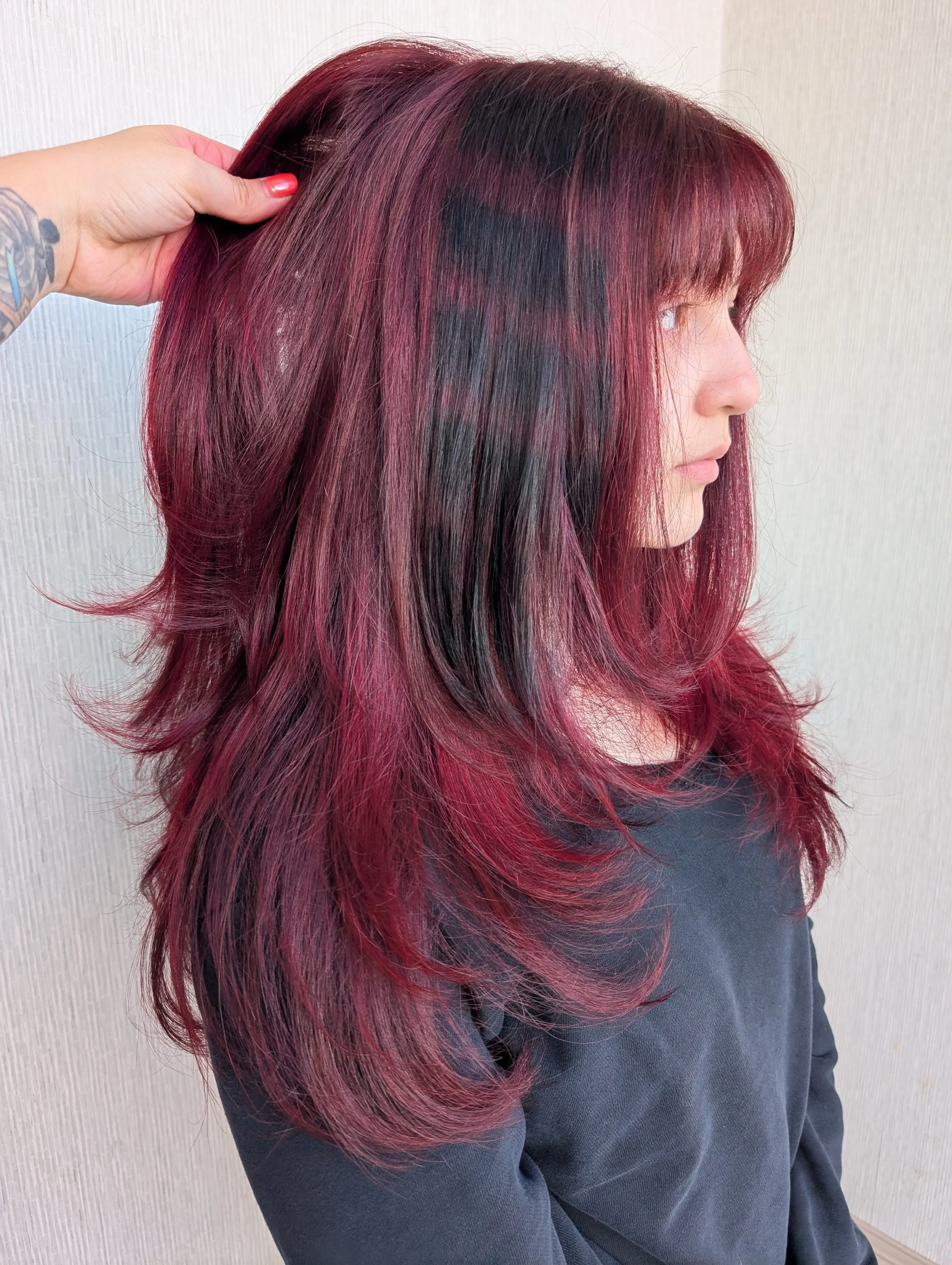 girl with maroon colored highlights and styling