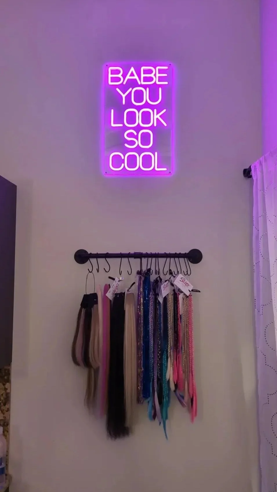 neon sign saying babe you look so cool with display of wild strand extensions