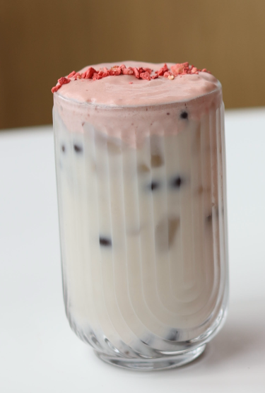 Jasmine Cloud / Jasmine milk tea with strawberry cold foam and brown sugar popping boba. Served iced, 16 oz.