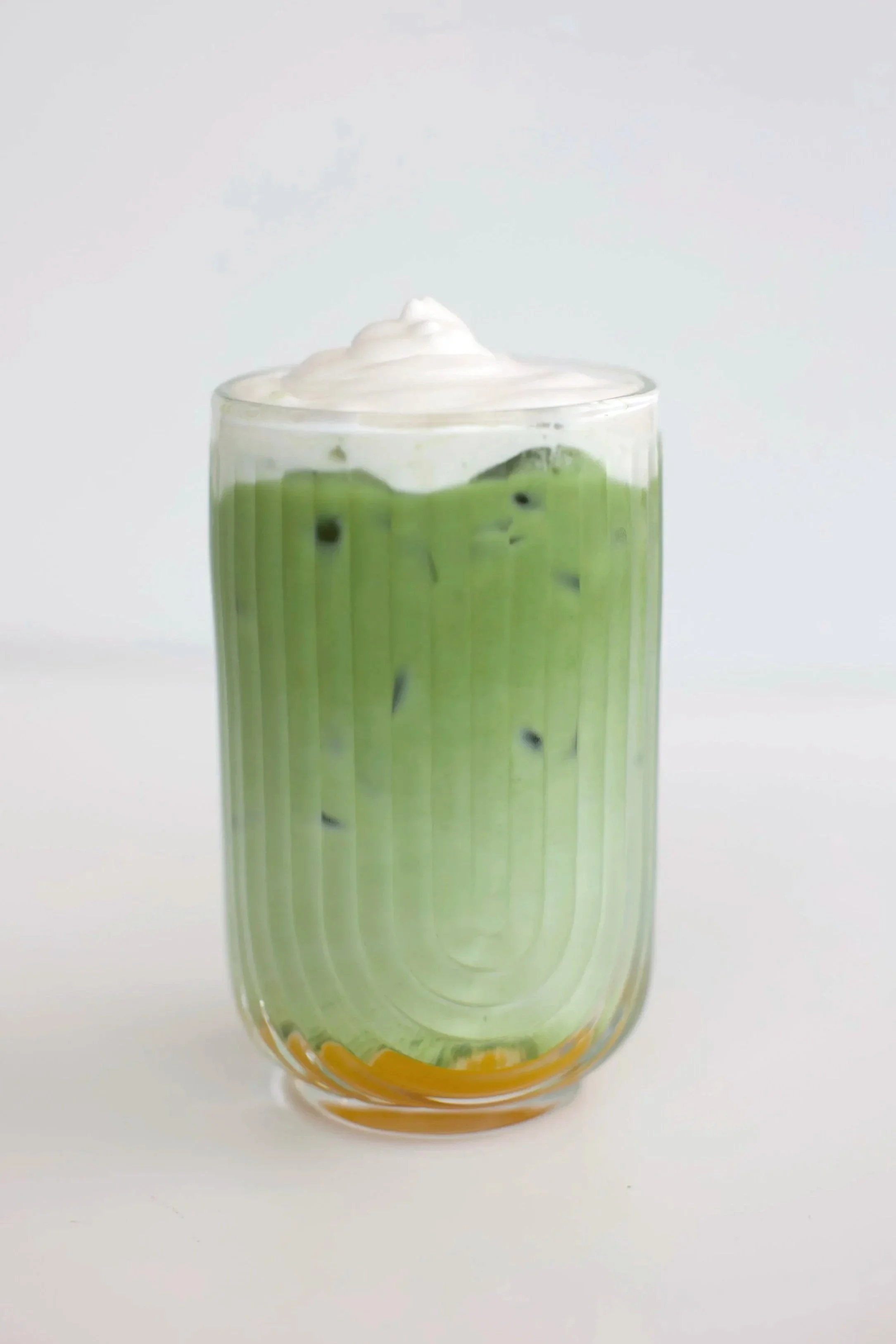 Mango Coconut Matcha Latte / Matcha and whole milk layered with sweet mango purée and finished with a fluffy coconut cream cold foam. A refreshing take on the classic mango sticky rice dessert. Served iced, 16 oz.